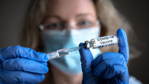 COVID-19 coronavirus vaccine in doctor hands
