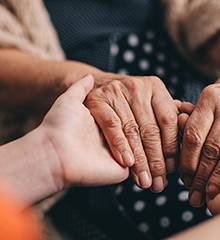 person holding elderly hands